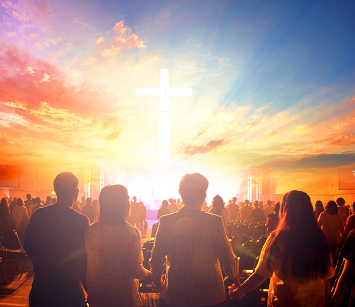 Group of people looking at bright Cross